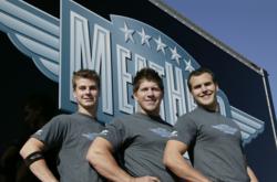 3 Meathead Movers standing in front of a moving truck.